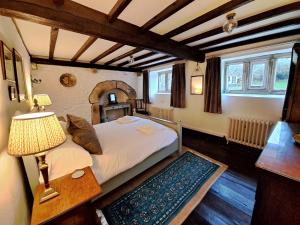 a bedroom with a bed and a table with a lamp at Countersett Hall in Askrigg