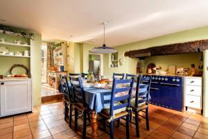 a kitchen with a table with a blue table cloth at Cossington Park Estate in Cossington