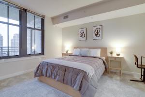 a bedroom with a large bed and a large window at Top Condo At Pentagon City with Gym in Arlington