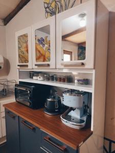 a kitchen with a counter with a coffee maker at Puna Hostel in San Pedro de Atacama