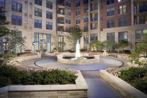 a fountain in a courtyard in front of a building at Top Condo At Pentagon City with Gym in Arlington