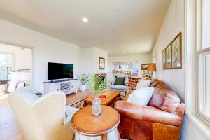 a living room with a couch and a table at The Farmhouse Cottage in Burley