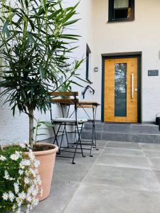 a table and chair in front of a door at Galerie Apartment Self-Check-In in Kolbermoor