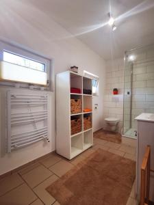 a bathroom with a toilet and a white refrigerator at Ferienwohnung life is life in Boltenhagen