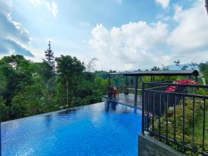 a view of a swimming pool on a balcony at Villa Cisarua RJS in Brujul