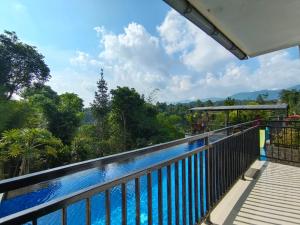 a balcony with a view of the forest at Villa Cisarua RJS in Brujul