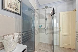 a bathroom with a shower with a glass door at LadyM in Rabac