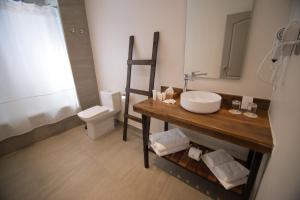 a bathroom with a sink and a toilet at Hotel Enjoy Pucon in Pucón