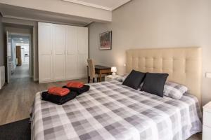 a bedroom with a large bed with two pillows on it at Apartamento del Monasterio in Talavera de la Reina
