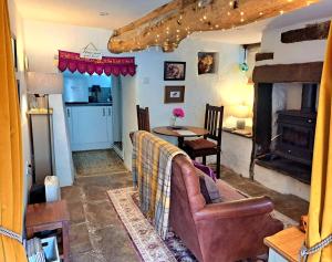 a living room with a couch and a table at Beebole Cottage in Askrigg