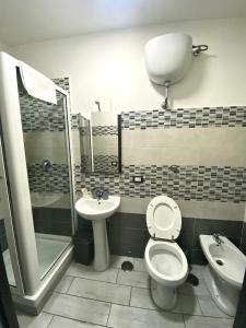 a bathroom with a toilet and a sink at fitta camere portanolana in Naples