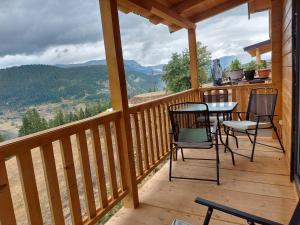 a porch with chairs and a table on a deck at Villa Te Ibra - Rugovë in Peje