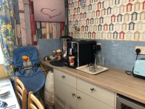 a small kitchen with a counter with a blue gmaxwell gmaxwell gmaxwell at Briny View Hotel in Blackpool