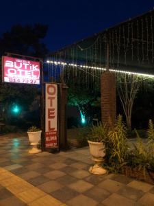 a sign for a store with lights on it at Anamur Butik Otel in Anamur