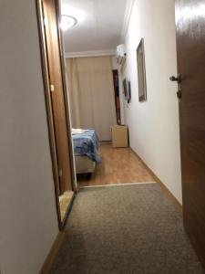 a hallway with a door leading to a room with a bed at Anamur Butik Otel in Anamur