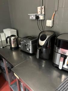 a kitchen counter with a stove and a toaster at Stay in Kings Cross in London