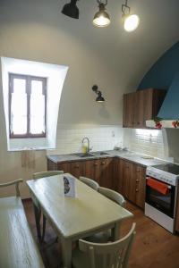 una cocina con una mesa de madera, una mesa y una mesa y una mesa con mesa en Stylianos House 1, en Leonidio