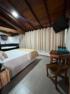 Ένα ή περισσότερα κρεβάτια σε δωμάτιο στο Pousada Mar Mineiro Macacos