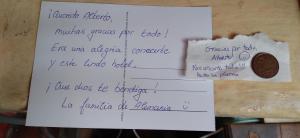 a piece of paper with a note and a penny at AylluWasi Guesthouse in Otavalo +67 photos