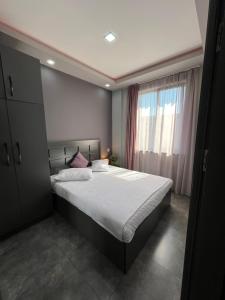 Un dormitorio con una cama grande y una ventana en COMFORTABLE APARTMENT КОМФОРТНЫЕ АПАРТАМЕНТЫ Self Check In en Ereván