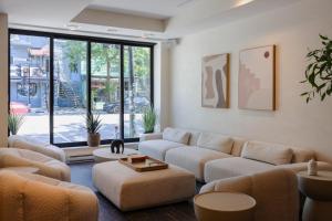 a living room with couches and a large window at hotel & spa Carré Saint-Louis in Montréal