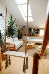 a room with a swing with plants in it at White Loft in the Riga City Center in Rīga