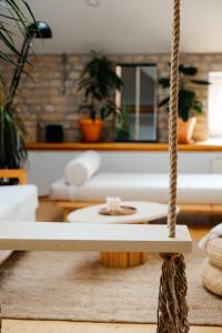 a living room with a rope swing at White Loft in the Riga City Center in Rīga