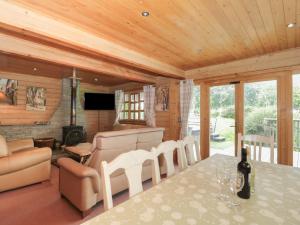 a living room with a table and chairs and a couch at Pine in Swanage