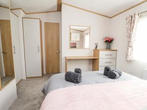um quarto com uma cama com duas almofadas pretas em Silverdale View em Ganton