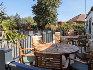 a patio with a table and chairs and a fence at Silverdale View in Ganton