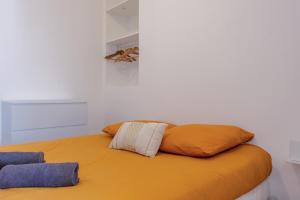 a bed with two pillows on top of it at La Perle Citadine En Hyper Centre in La Rochelle
