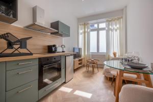 a kitchen with a table and a dining room at La Perle Citadine En Hyper Centre in La Rochelle