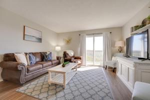 a living room with a couch and a tv at Brandon Condo with Balcony, Strip and Mountain Views! in Branson