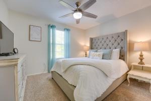 a white bedroom with a bed and a ceiling fan at Brandon Condo with Balcony, Strip and Mountain Views! in Branson