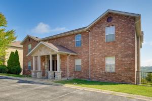 a red brick house with a driveway at Brandon Condo with Balcony, Strip and Mountain Views! in Branson