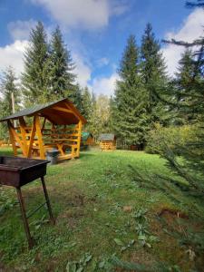 a gazebo and a picnic table in a yard at Отель MONBLAN in Yablunytsya