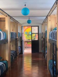 a room with bunk beds and a door with a painting at Planet Hostel in San Cristóbal de Las Casas