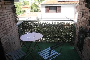 a patio with a table and two glasses of wine at Capital House Roma in Rome