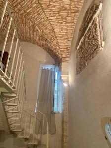 a staircase in a house with a brick ceiling at PalazzOliva - Boho chic Guest house in the historic heart of Martina Franca in Martina Franca