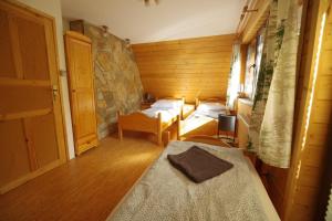 1 dormitorio con 2 camas en una habitación de madera en Ski House Szczyrk - Solisko en Szczyrk
