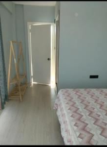 a white room with a bed and a door at Toskana otel restorant in Şarköy