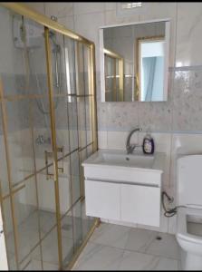 a bathroom with a shower and a sink and a mirror at Toskana otel restorant in Şarköy