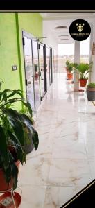 a hallway with potted plants in a building at Complexe Hôtelier AnD in Ouagadougou