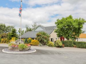 a house with a flag in front of it at Hazel Lodge in Newton Abbot