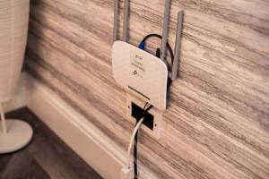 a lightswitch on a wall with a wooden wall at Little Retreat in Woodhouse