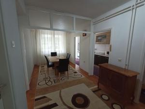 a kitchen and dining room with a table and chairs at Apartmani Vesna in Banja Luka