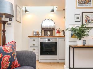 a living room with a couch and a counter at Butterrow Gate in Stroud