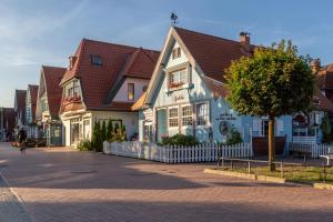 a building with a cross on top of it on a street at Ferienwohnung Harmonie in Boltenhagen