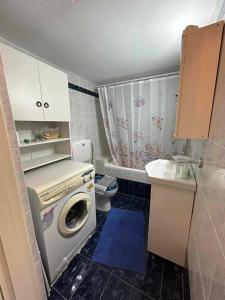 a small bathroom with a washing machine and a sink at Avgoustina's Home in Glossa +63 photos