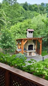 a outdoor oven in the middle of a garden at Cabana Mistic in Bran